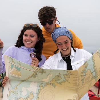 Students look at a map for directions