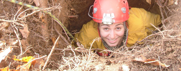 A student exits a wombat pit in fieldwork with Dr. Greg Springer.