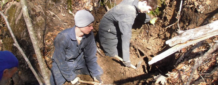 Students work on digging a blowhole discovered using a passive infrared camera.