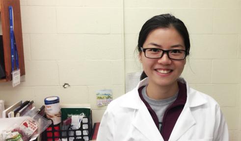 Chang Xu in white lab coat, in her lab