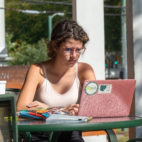 Student studying outside using a laptop