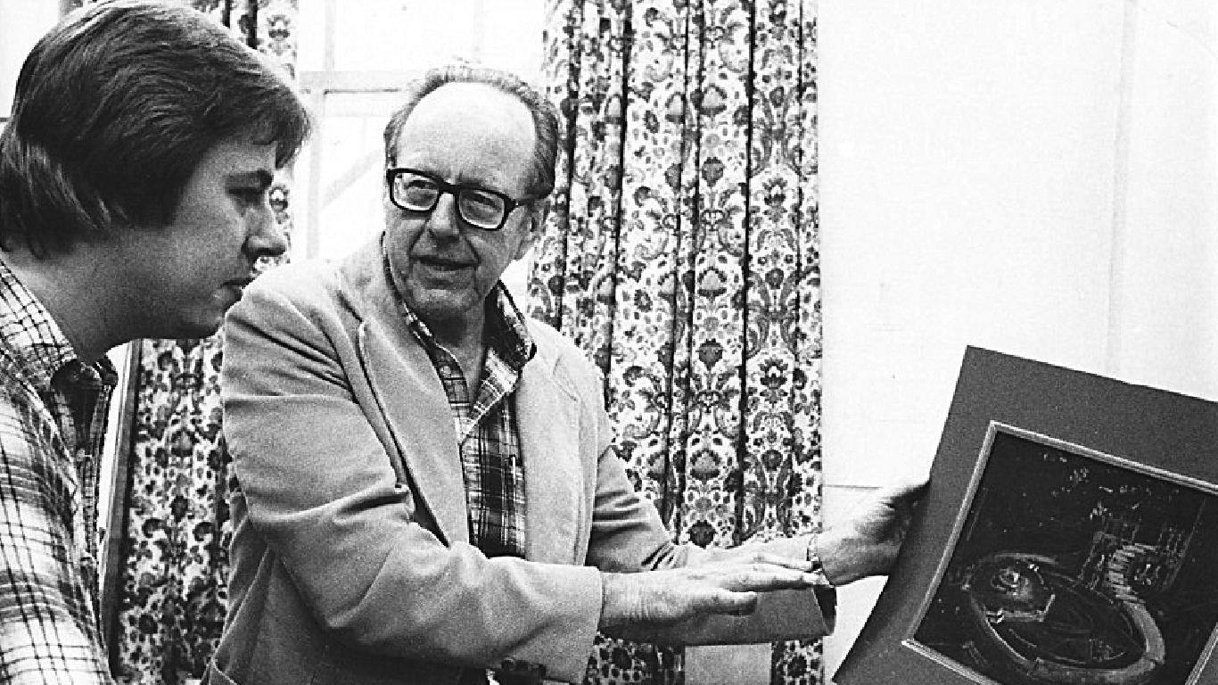 Robin Lacy, right, instructing then-student and now Professor of Production Design and Technology Daniel Denhart in the secrets of his sketch and model of a setting for the Joker of Seville.