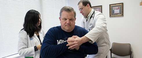 Man receiving treatment at the OMM Clinic