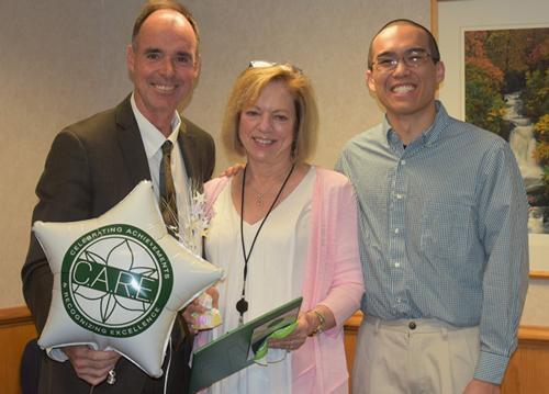 Kathy Pittman holding award with two others