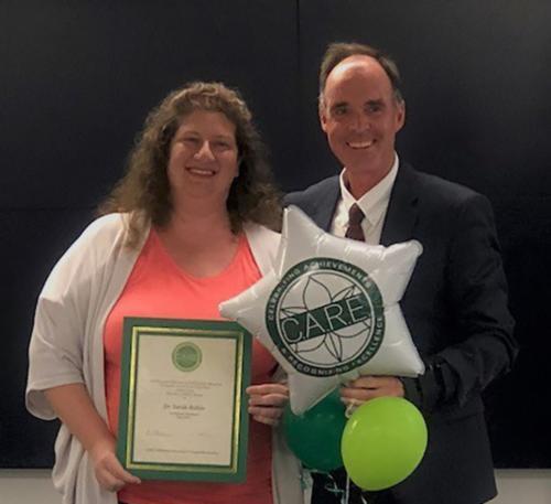 Sarah Rubin holding award