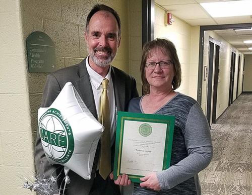 Tammy Loper holding award