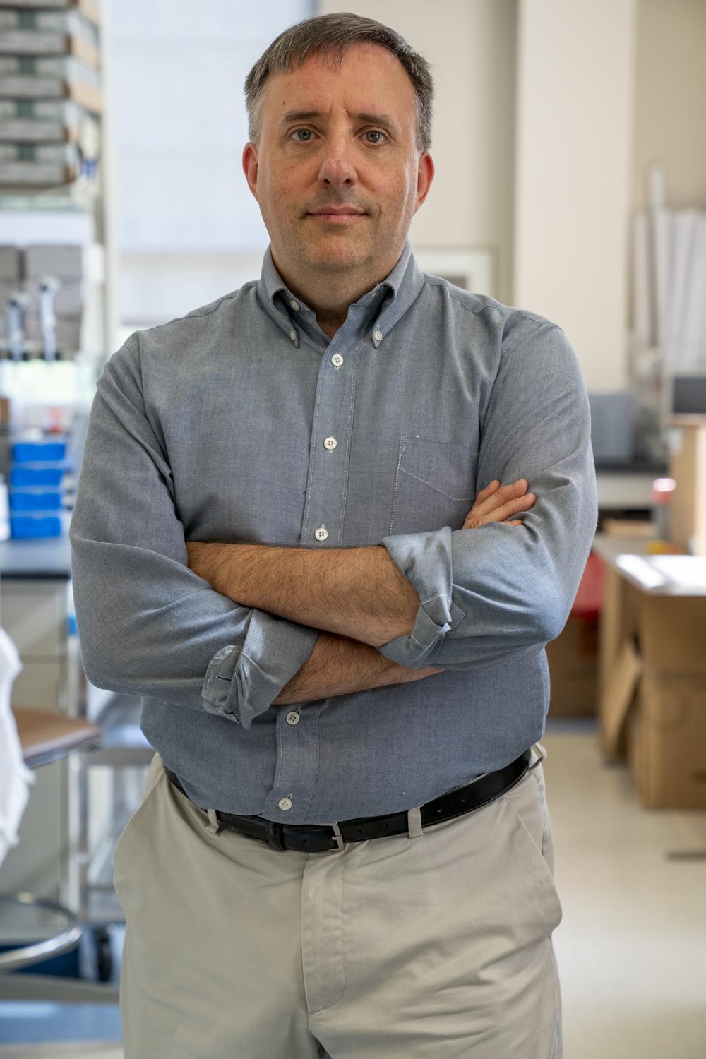 Craig Nunemaker, PhD portrait with science lab in background