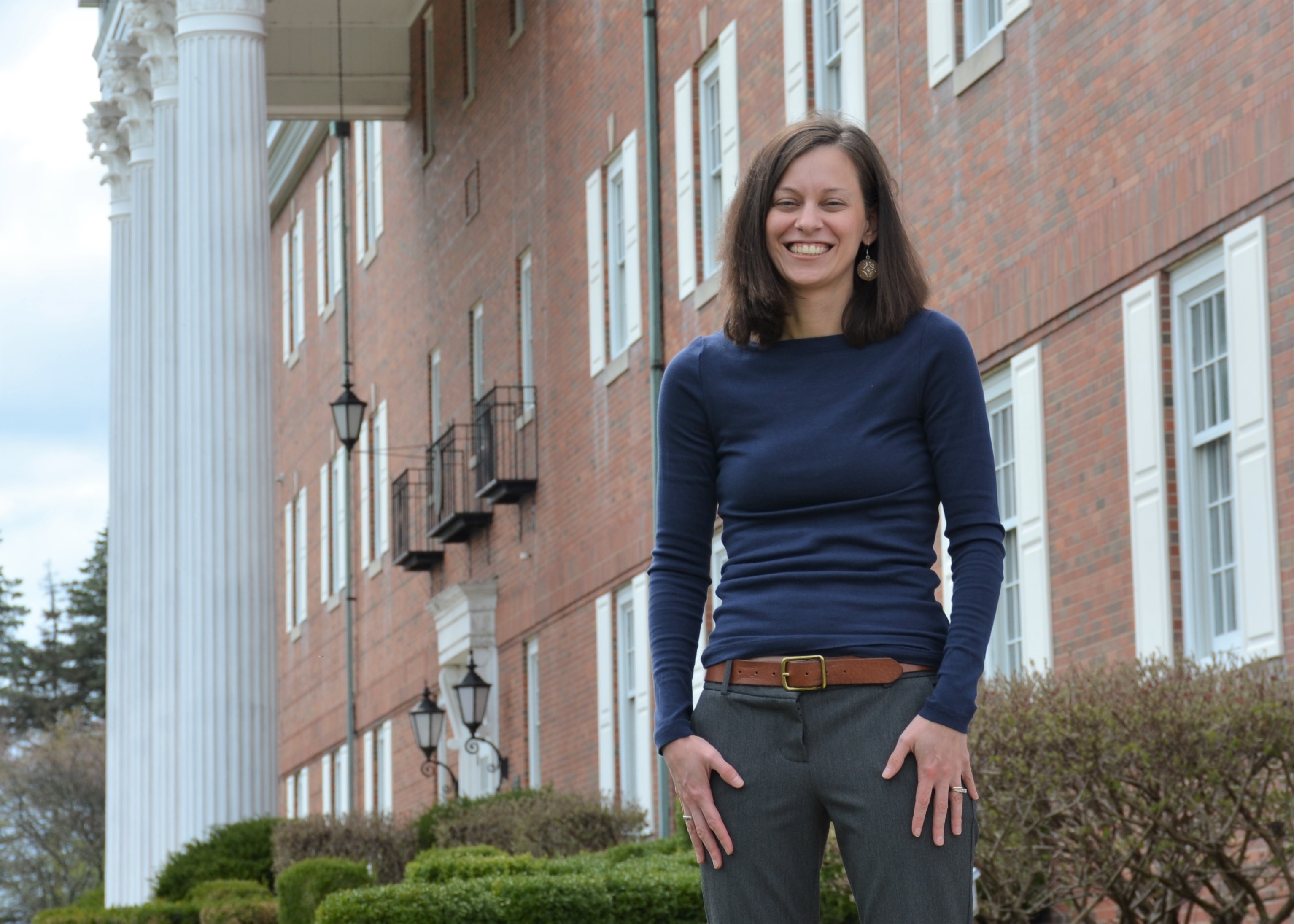 Woman standing in front of brick building