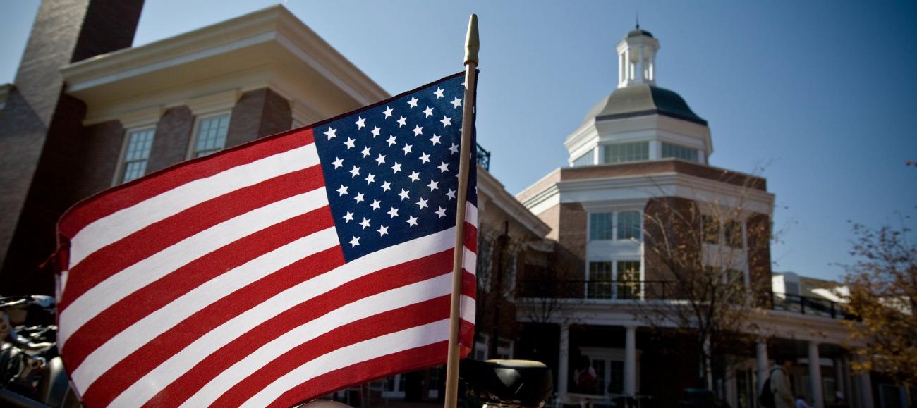 An American flag in front of a campus building