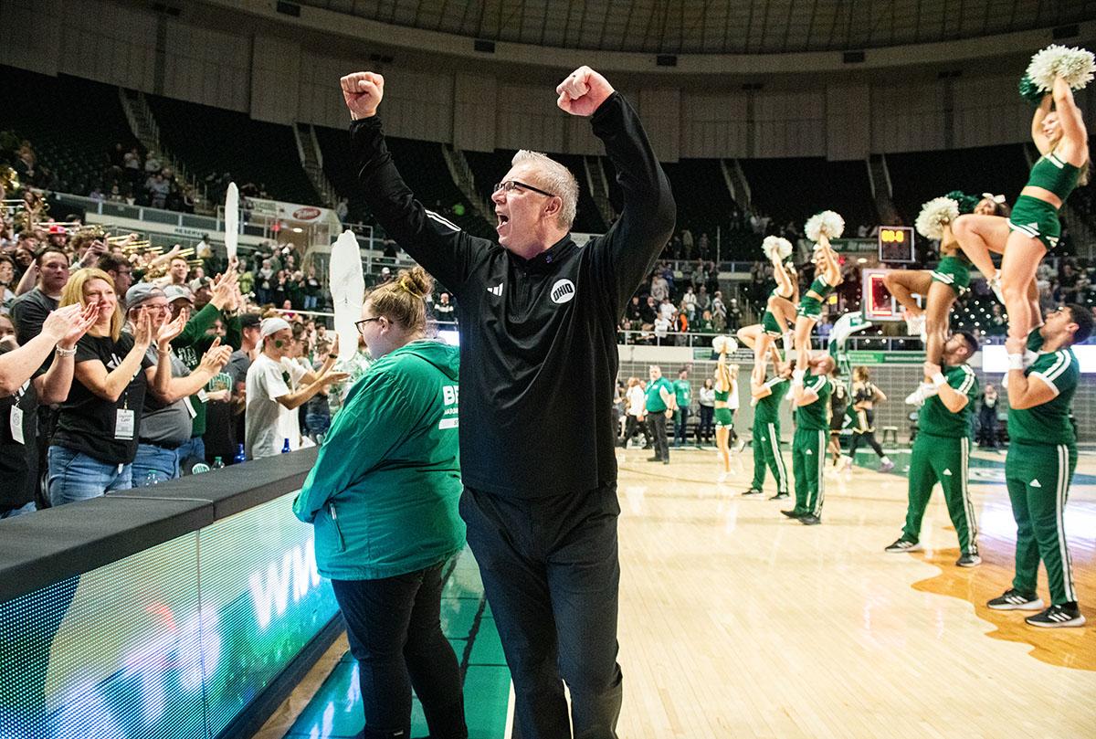 Ohio Men’s Basketball head coach Jeff Boals raises his arms in celebration to the crowd