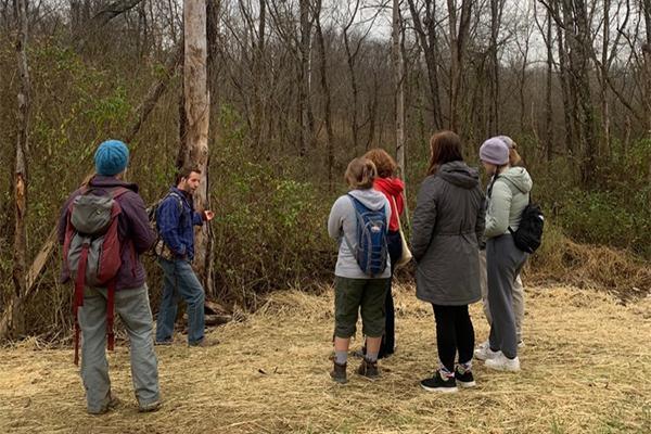 Students stand in the wilderness