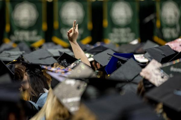 Students wear caps and gowns during Commencement