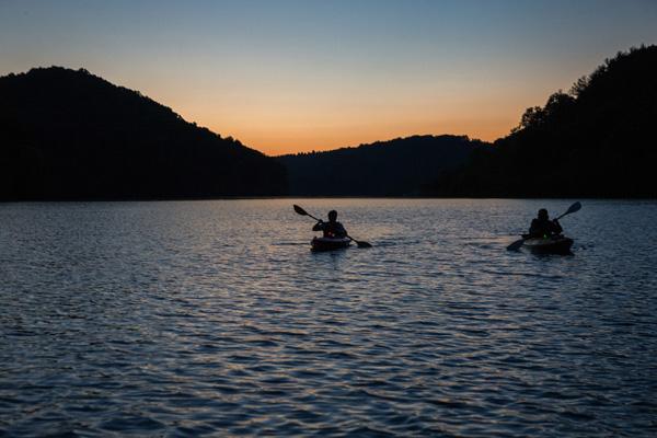 Students kayak at sunset at Strouds Run