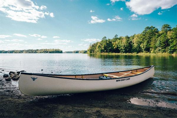 A canoe sits near a lake