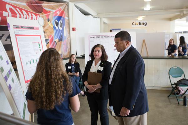 Student gives poster presentations at a creativity and science expo