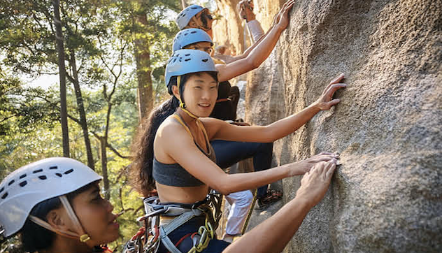 A group of students learning to rock climb