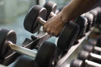 Dumbells being lifted off rack.