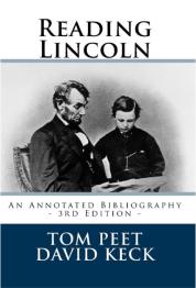 Lincoln sitting in chair looking at book in his hands and child looking over his shoulder.