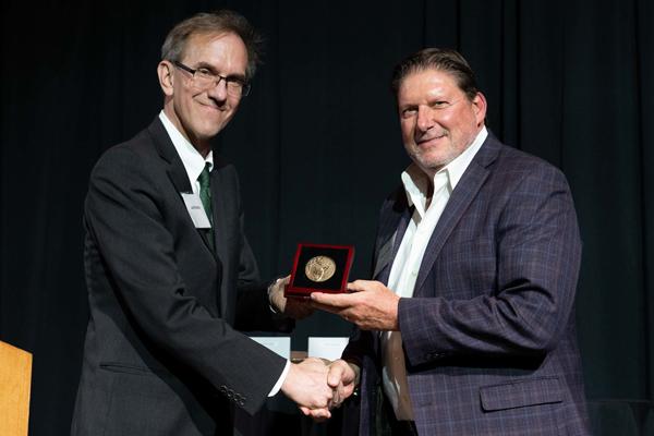 Joe Shields is shown with alumnus Steve Snyder