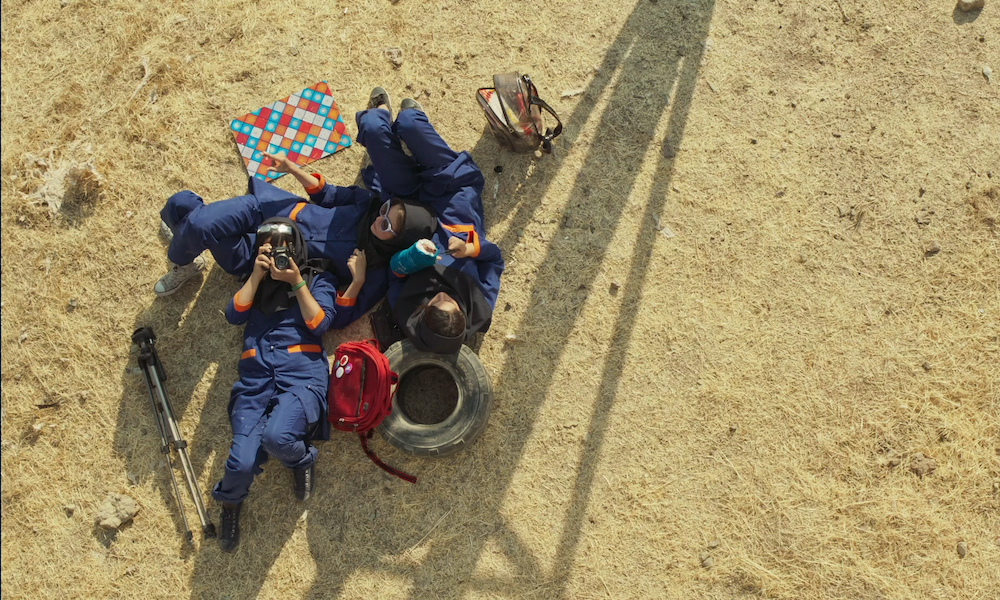 A still from Solar Eclipse showing three actors from a bird's eye view