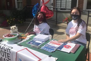 Campus Election Engagement Project Fellows Sarah Donaldson (left) and Reese Campbell share voter information outside the Athens County Courthouse before the November election.