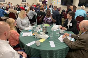 Leading in Appalachia attendees sitting and conversing at round tables