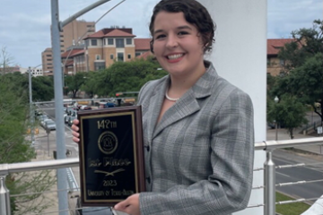 Mackenzie Joseph is shown holding the championship award