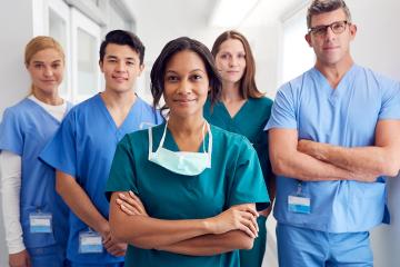 Medical Team Standing In Hospital Corridor