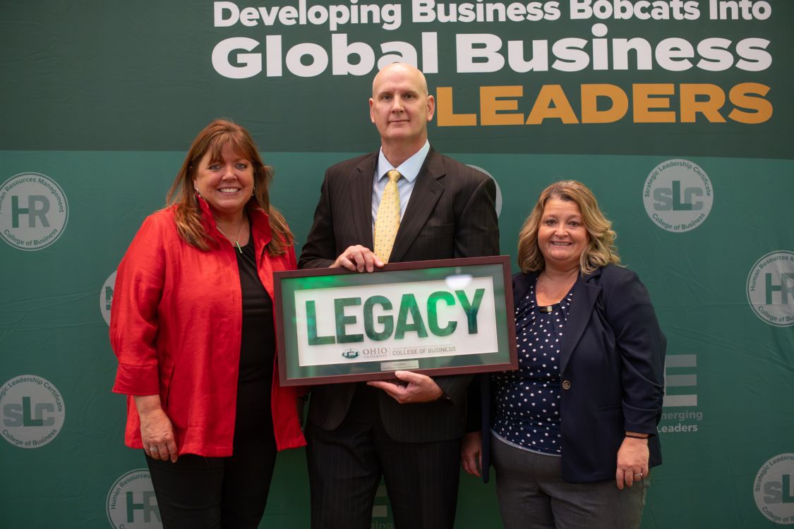 Greg Moran receiving the Legacy Award from Executive Director Jen Traxler and Amy Toth
