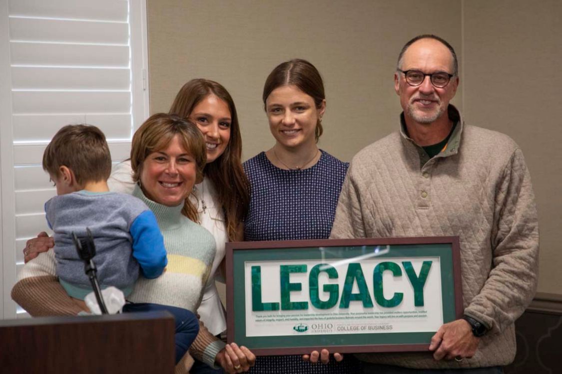 Tim Reynolds receiving Legacy Award with wife Tammy, and students Natalie and Rachel, and grandson Eli
