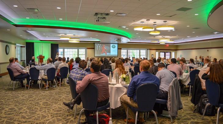 Attendees listen during a conference