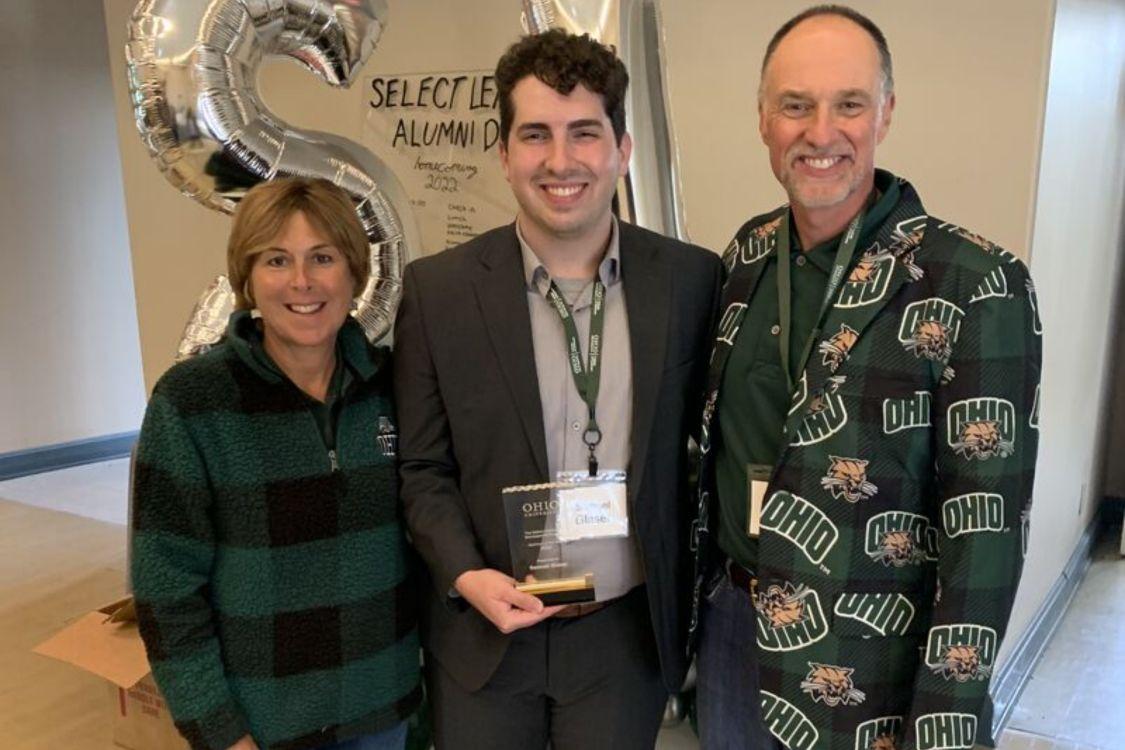 Sam Glaser pictured with Tim and Tammy Reynolds as he accepts his Alumni of the year award.