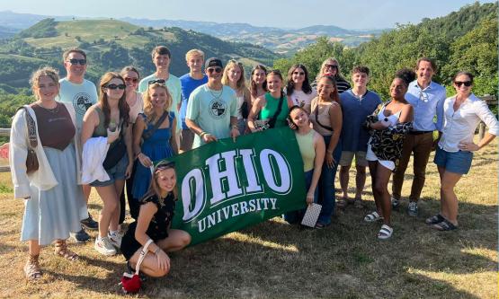 GCP Group Photo holding Ohio Flag in Italy