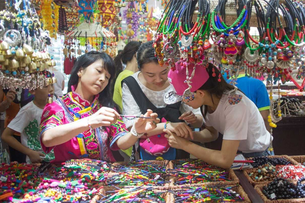 An Asian business, with women making jewelry and beads.