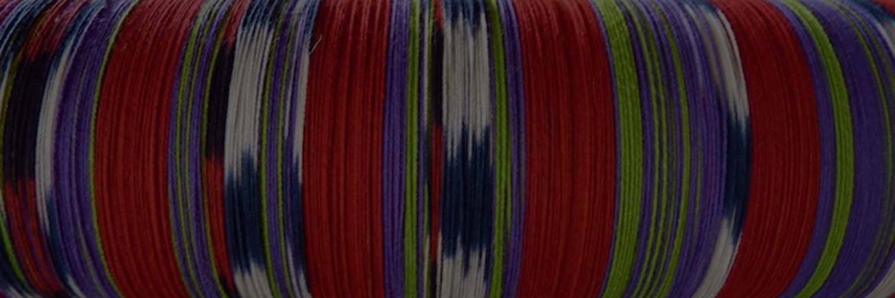 A master weaver's spindle of brightly colored yarn