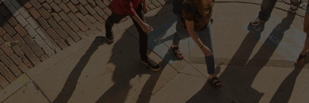 Students -- and their shadows -- crossing the street in Athens