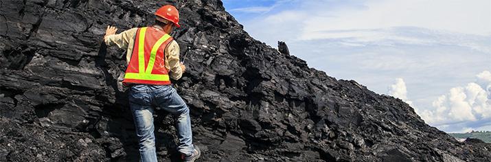 highway worker climing on rocks