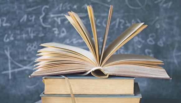 Photo of books and blackboard with math formulas