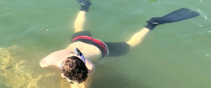 Graduate student Neil Hamrick collects swordtail fish.