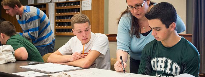 Dr. Julie Roche works with students in a flipped classroom.