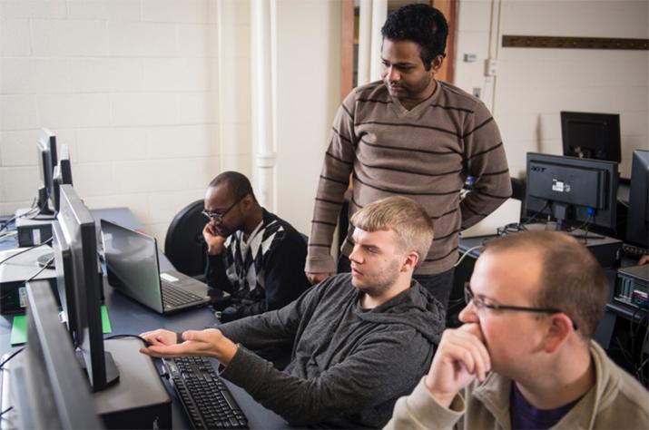 Four students in physics lab