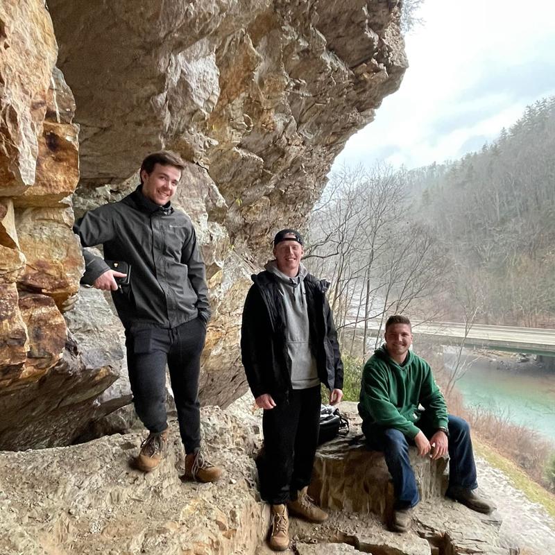 Students at Central Appalachian field school, on a rock shelf above a stream