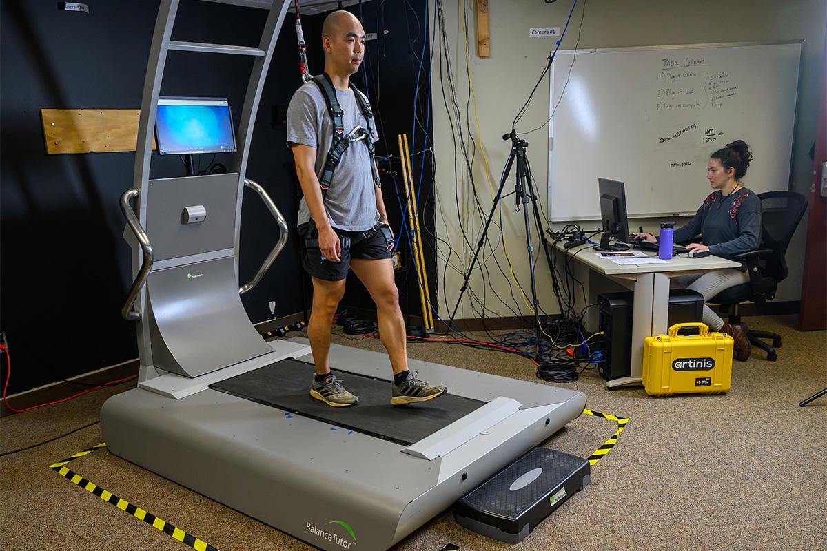 A patient walks on the Balance Tutor Treadmill.