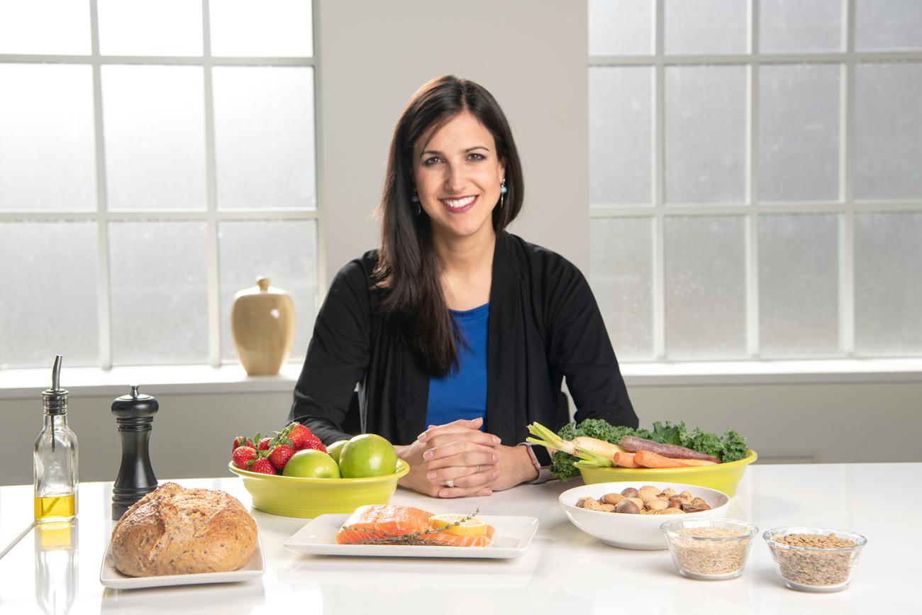 Woman sitting at table with food in front of her