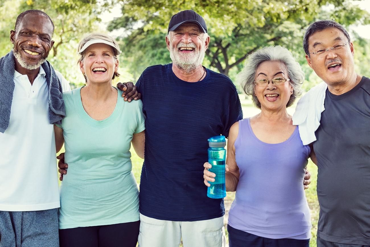 Group of elderly people posing for a photo in the park