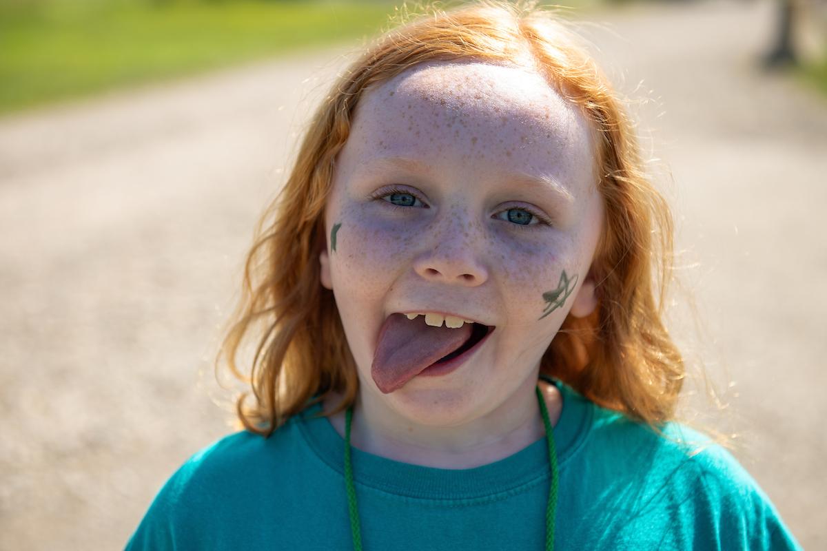 young child sticking out their tongue