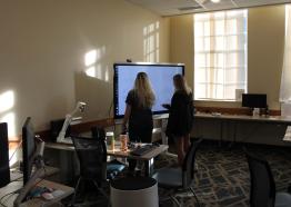 Center for Technology and Online Programs Innovation Lab showing students at a SmartBoard