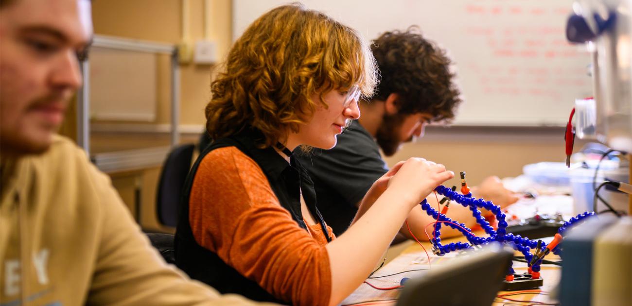 Students work on robots in a mechanical engineering lab