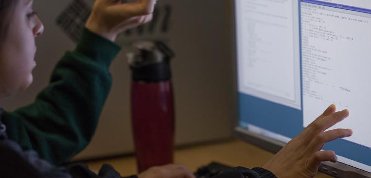 An Electrical Engineering and Computer Science student works on a computer