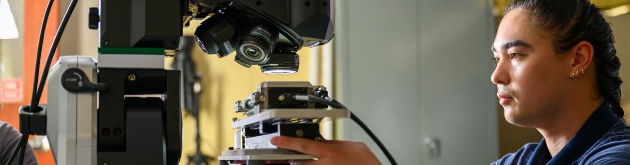 A mechanical engineering student works at a machine.